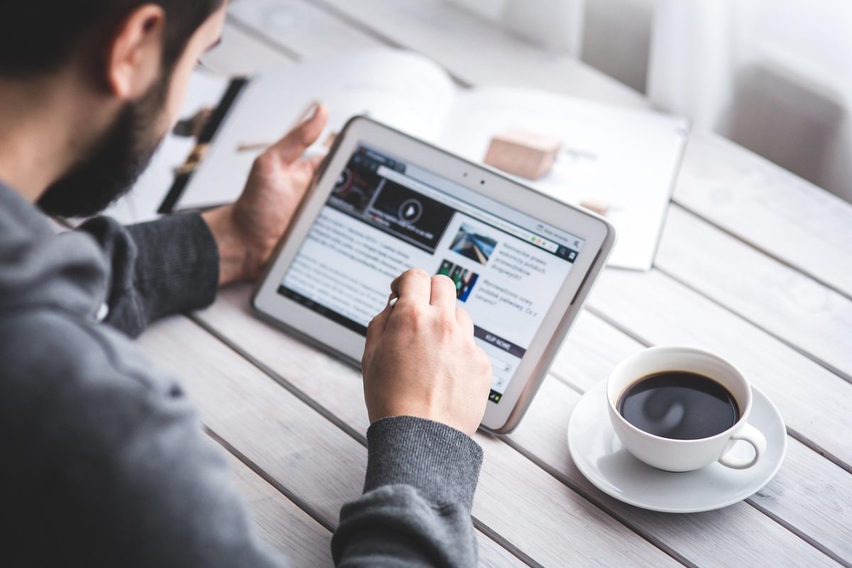 Man, reading, touchscreen — Hassle-Free Nangs Delivery Available Across Sydney